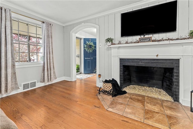 55 Evergreen Ter, Uniontown, PA 15401 - unfurnished living room with ornamental molding, a fireplace with flush hearth, arched walkways, wood finished floors, and baseboards