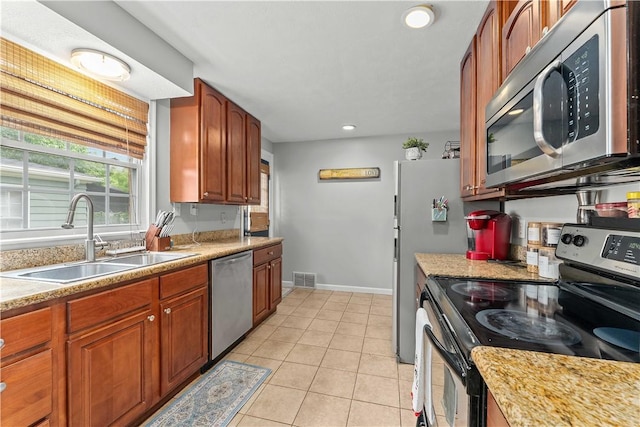 55 Evergreen Ter, Uniontown, PA 15401 - kitchen featuring appliances with stainless steel finishes, a sink, baseboards, light countertops, and light tile patterned flooring
