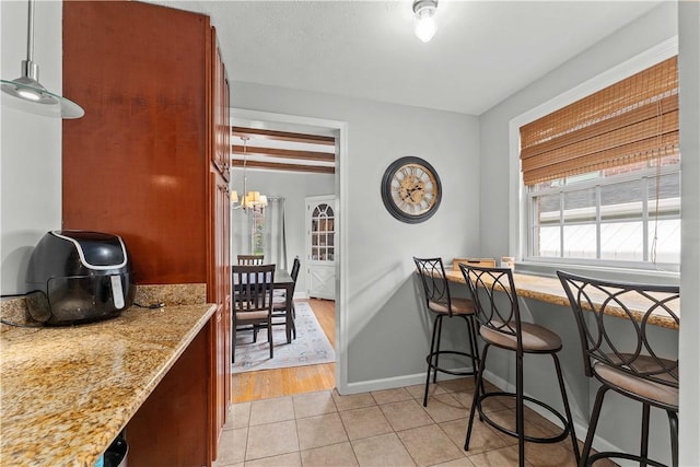 55 Evergreen Ter, Uniontown, PA 15401 - dining space featuring a chandelier, light tile patterned floors, and baseboards