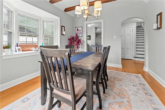 55 Evergreen Ter, Uniontown, PA 15401 - dining area with a chandelier, arched walkways, baseboards, and wood finished floors
