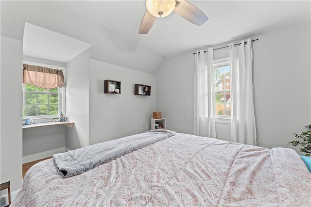55 Evergreen Ter, Uniontown, PA 15401 - bedroom with multiple windows, vaulted ceiling, a ceiling fan, wood finished floors, and baseboards