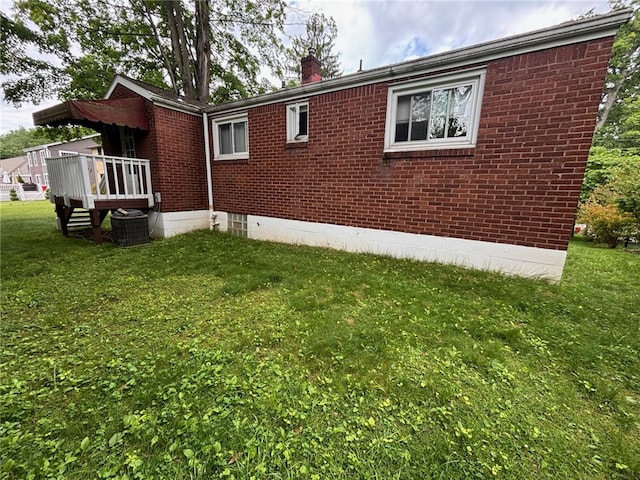 1132 Onondago St, Squirrel Hill, PA 15218 - view of side of property with a chimney, a yard, brick siding, a wooden deck, and central air condition unit