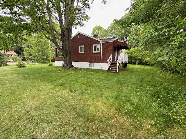 1132 Onondago St, Squirrel Hill, PA 15218 - view of home's exterior with brick siding, a yard, and a chimney