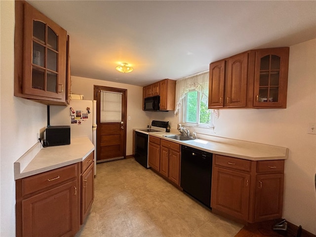 1132 Onondago St, Squirrel Hill, PA 15218 - kitchen featuring black appliances, a sink, light countertops, glass insert cabinets, and brown cabinetry
