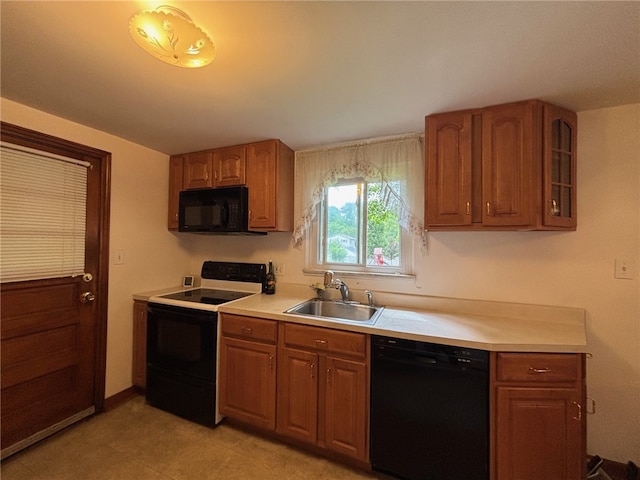 1132 Onondago St, Squirrel Hill, PA 15218 - kitchen featuring black appliances, a sink, light countertops, and brown cabinetry
