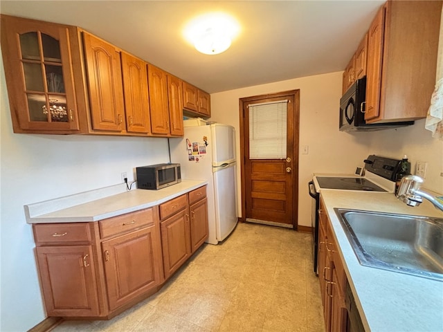 1132 Onondago St, Squirrel Hill, PA 15218 - kitchen featuring white appliances, a sink, glass insert cabinets, light countertops, and brown cabinets