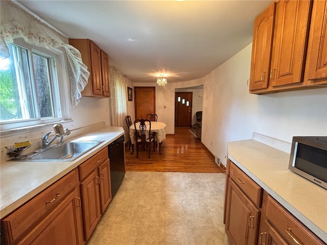 1132 Onondago St, Squirrel Hill, PA 15218 - kitchen featuring a sink, stainless steel microwave, light countertops, dishwasher, and brown cabinets