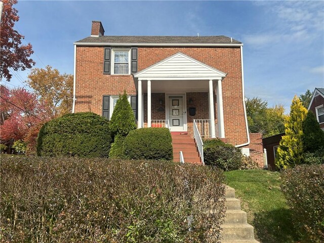 4735 Stanton Ave, Stanton Heights, PA 15201 - view of front of house with brick siding, covered porch, and a chimney