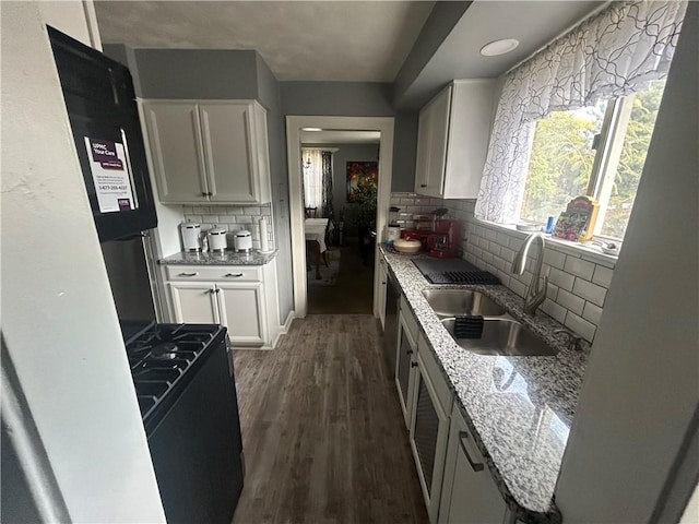 4735 Stanton Ave, Stanton Heights, PA 15201 - kitchen featuring a sink, white cabinets, decorative backsplash, light stone counters, and dark wood-type flooring
