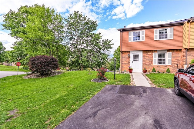 101 Canyon Ct, Unity Twp, PA 15650 - colonial house featuring a front yard and brick siding