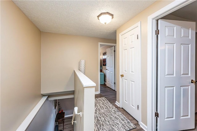 101 Canyon Ct, Unity Twp, PA 15650 - hallway featuring dark wood-style floors, a textured ceiling, and baseboards