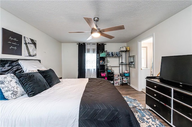 101 Canyon Ct, Unity Twp, PA 15650 - bedroom with wood finished floors, a textured ceiling, ceiling fan, and baseboards