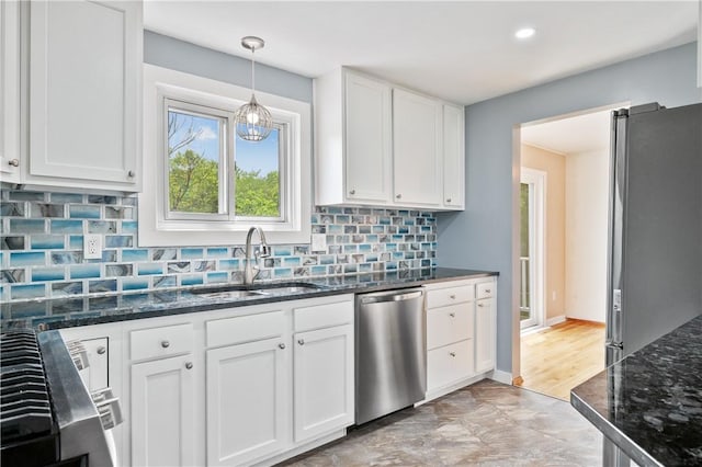 34 Eichelberger Dr, Robinson Twp Nwa, PA 15108 - kitchen featuring appliances with stainless steel finishes, a sink, white cabinets, dark stone countertops, and backsplash