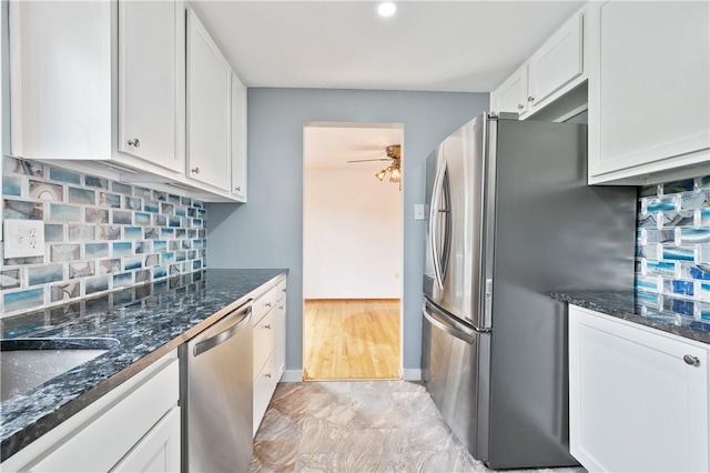 34 Eichelberger Dr, Robinson Twp Nwa, PA 15108 - kitchen with appliances with stainless steel finishes, white cabinets, ceiling fan, dark stone countertops, and decorative backsplash