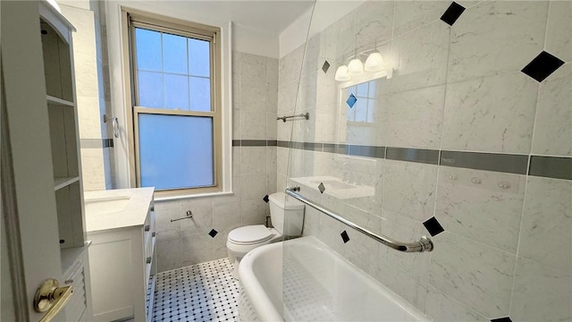 144 N Dithridge St Unit 703, Oakland, PA 15213 - bathroom with toilet, tile walls, vanity, and a tub to relax in
