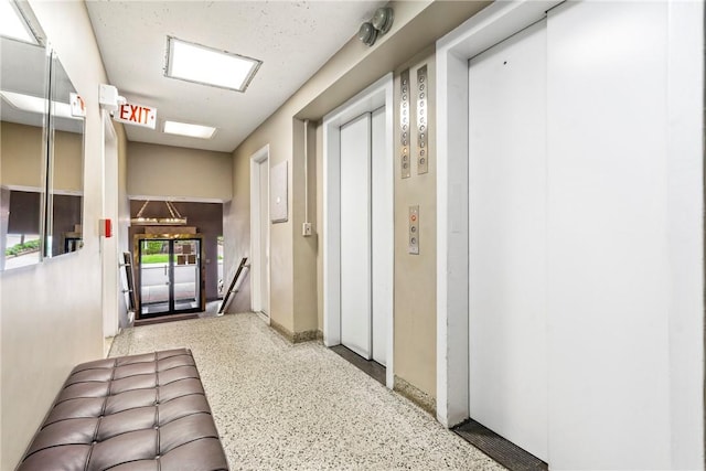 144 N Dithridge St Unit 703, Oakland, PA 15213 - hallway with elevator, speckled floor, and baseboards