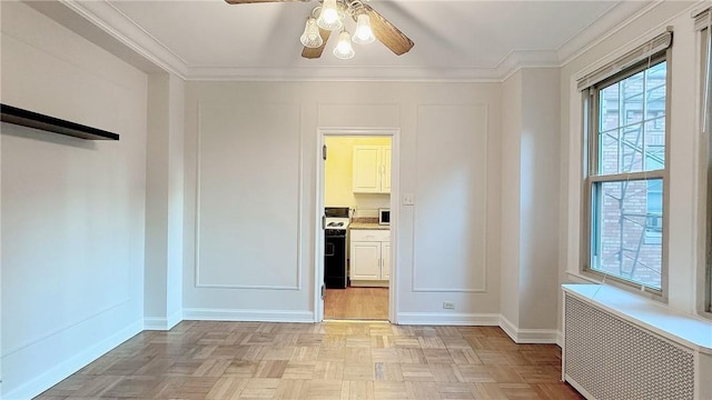 144 N Dithridge St Unit 703, Oakland, PA 15213 - spare room featuring radiator heating unit, ceiling fan, baseboards, and crown molding