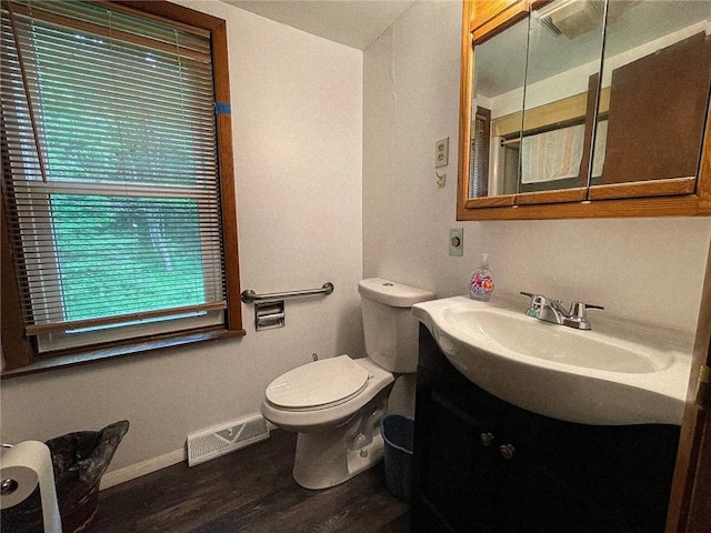 141 Minich Rd, Center Twp But, PA 16001 - bathroom featuring vanity, toilet, baseboards, and wood finished floors
