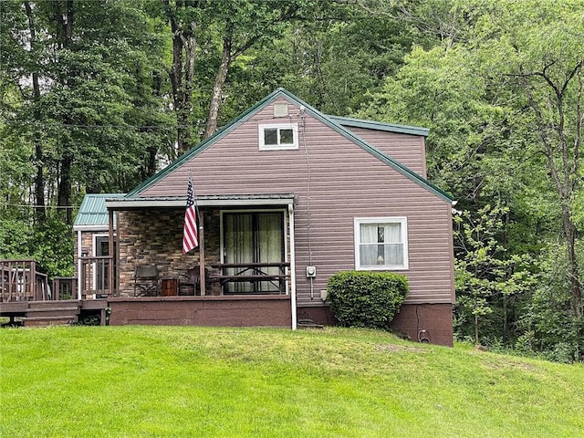 141 Minich Rd, Center Twp But, PA 16001 - back of property featuring a lawn, a forest view, stone siding, and metal roof