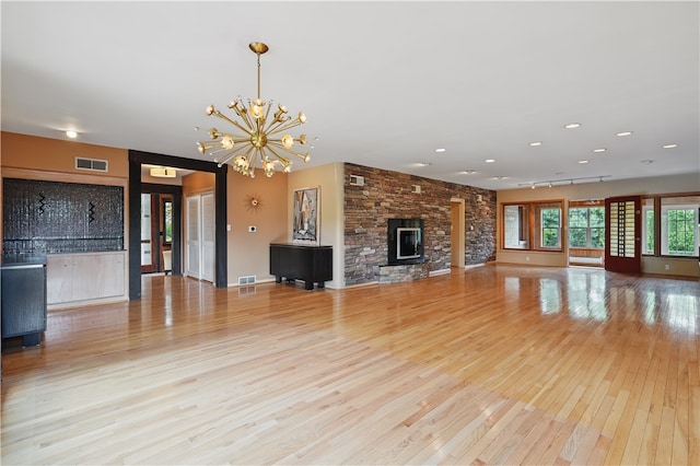 107 Belmont Cir, Uniontown, PA 15401 - unfurnished living room featuring hardwood / wood-style flooring, a chandelier, recessed lighting, and a fireplace
