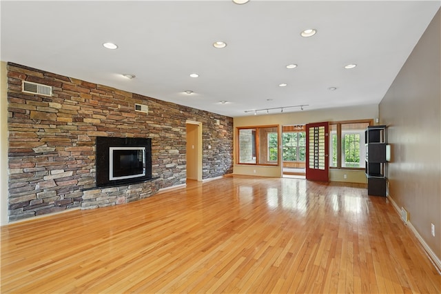 107 Belmont Cir, Uniontown, PA 15401 - unfurnished living room featuring light wood-style flooring, baseboards, a glass covered fireplace, and recessed lighting