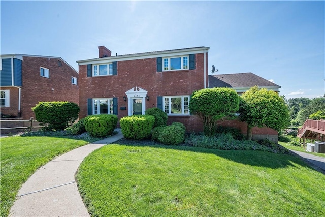 2443 Rose Garden Rd, Banksville/Westwood, PA 15220 - colonial house featuring brick siding, a chimney, a front yard, and cooling unit