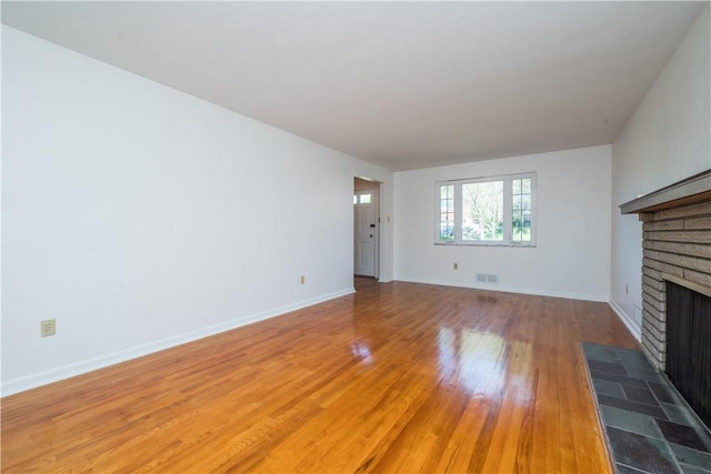 2443 Rose Garden Rd, Banksville/Westwood, PA 15220 - unfurnished living room with a fireplace, light wood-style floors, and baseboards