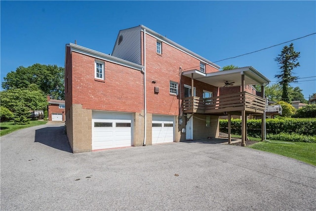 2443 Rose Garden Rd, Banksville/Westwood, PA 15220 - rear view of house featuring brick siding, an attached garage, driveway, a ceiling fan, and a deck