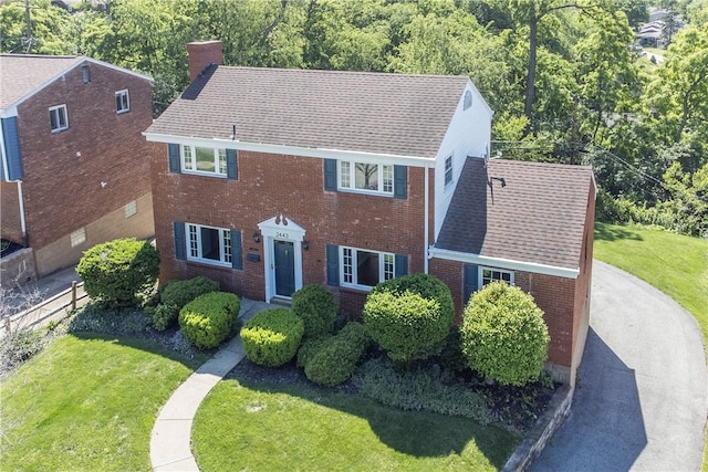 2443 Rose Garden Rd, Banksville/Westwood, PA 15220 - colonial house featuring a chimney, brick siding, a front yard, and roof with shingles