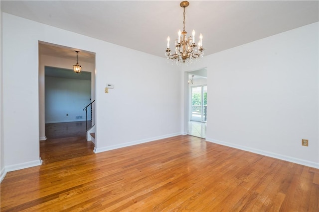 2443 Rose Garden Rd, Banksville/Westwood, PA 15220 - spare room with a chandelier, stairs, light wood-style flooring, and baseboards