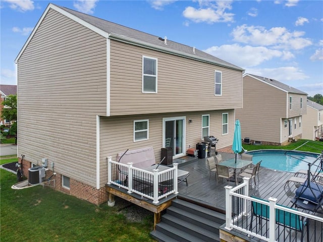 11572 Salerno Dr, North Huntingdon, PA 15642 - back of house with a lawn, central air condition unit, a wooden deck, an outdoor pool, and outdoor dining space