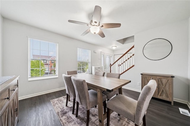 11572 Salerno Dr, North Huntingdon, PA 15642 - dining space with stairs, a ceiling fan, dark wood-type flooring, and baseboards