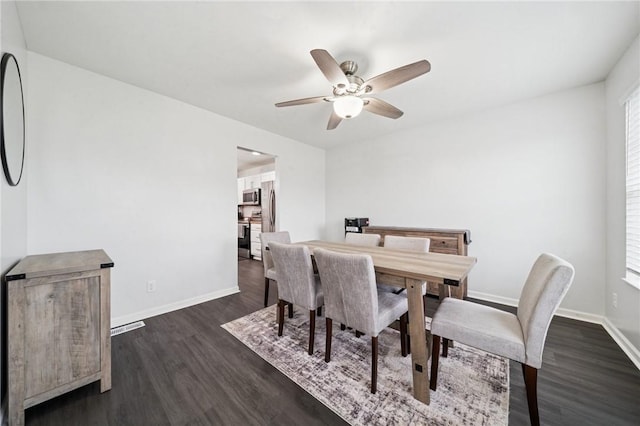 11572 Salerno Dr, North Huntingdon, PA 15642 - dining space featuring dark wood-type flooring, a ceiling fan, and baseboards