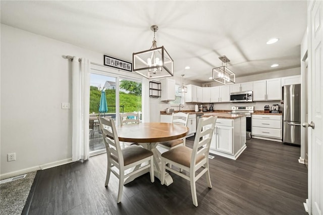 11572 Salerno Dr, North Huntingdon, PA 15642 - dining space with a chandelier, recessed lighting, dark wood finished floors, and baseboards