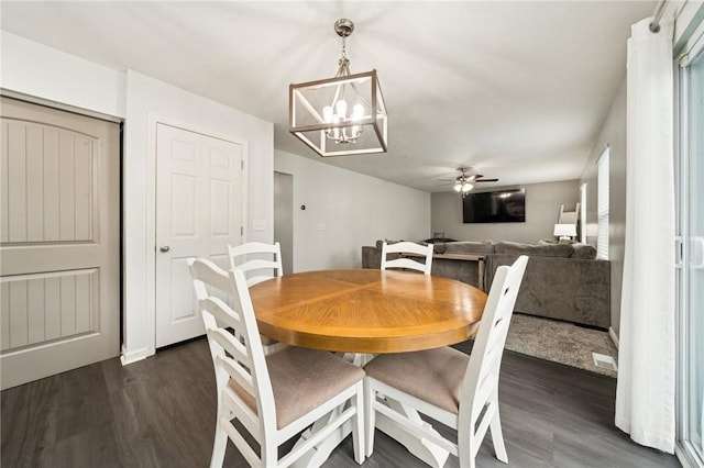 11572 Salerno Dr, North Huntingdon, PA 15642 - dining area with dark wood finished floors, a chandelier, and a ceiling fan