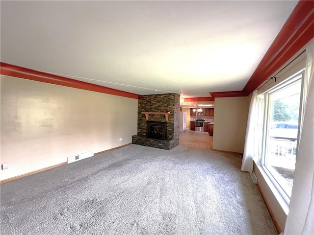 122 E Elizabeth St, New Castle/2Nd, PA 16105 - unfurnished living room featuring light colored carpet, baseboards, and a stone fireplace