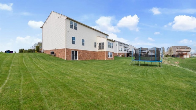 5 Heather Ct, Plum Boro, PA 15239 - back of property featuring a trampoline, a lawn, and central AC