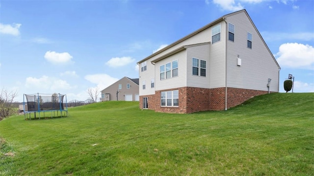 5 Heather Ct, Plum Boro, PA 15239 - view of side of property with a trampoline, a yard, and brick siding