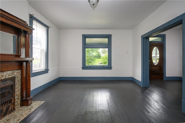 920 Roup Ave, Brackenridge, PA 15014 - unfurnished living room with healthy amount of natural light, baseboards, dark wood-type flooring, and a fireplace