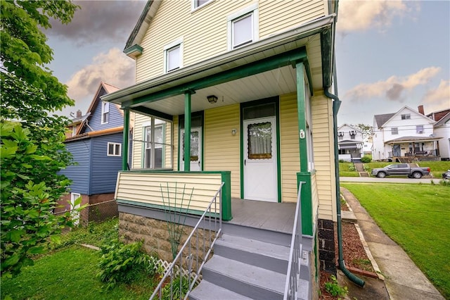 920 Roup Ave, Brackenridge, PA 15014 - doorway to property featuring a porch, a yard, and a residential view