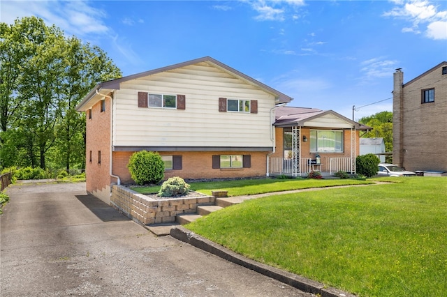 1317 Cathell Rd, Baldwin Boro, PA 15236 - tri-level home with a front lawn, brick siding, driveway, and covered porch