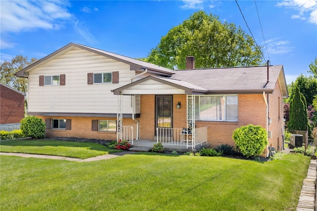 1317 Cathell Rd, Baldwin Boro, PA 15236 - tri-level home with brick siding, a front lawn, covered porch, and a chimney