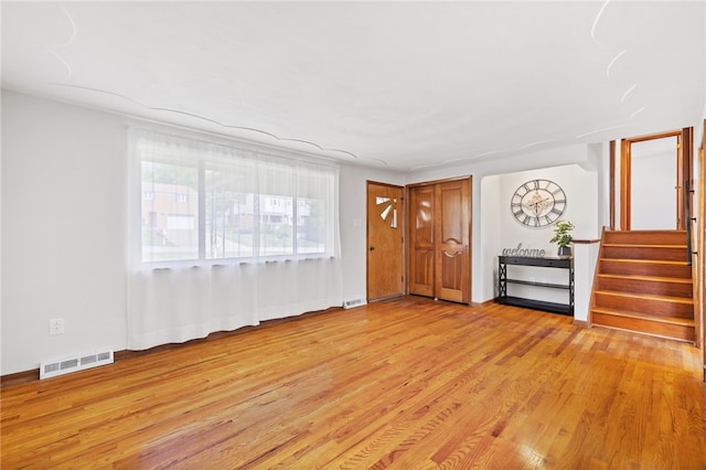 1317 Cathell Rd, Baldwin Boro, PA 15236 - unfurnished living room with light wood-type flooring and stairway