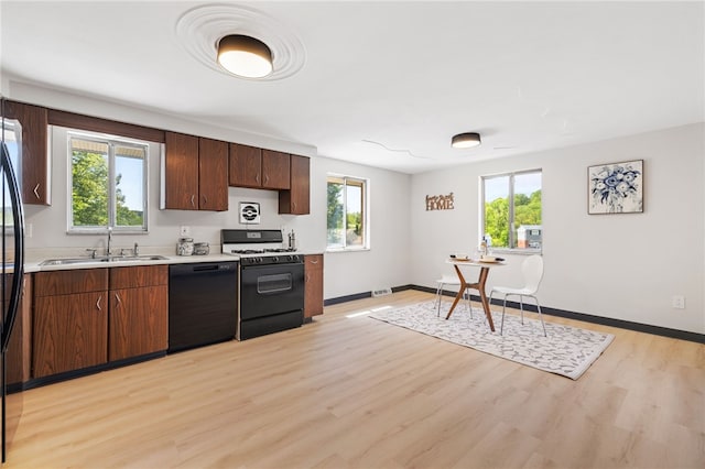 1317 Cathell Rd, Baldwin Boro, PA 15236 - kitchen with black appliances, light countertops, light wood-type flooring, and healthy amount of natural light