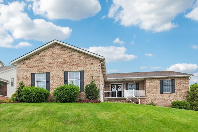 108 Covington Dr, Center Twp, PA 16001 - view of front of home with brick siding, a porch, and a front lawn