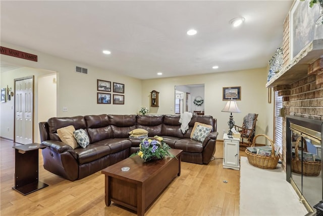 108 Covington Dr, Center Twp, PA 16001 - living area with light wood-type flooring, arched walkways, a brick fireplace, and recessed lighting