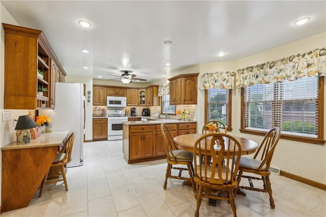 108 Covington Dr, Center Twp, PA 16001 - kitchen featuring white appliances, brown cabinets, plenty of natural light, and recessed lighting