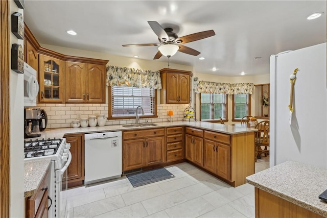 108 Covington Dr, Center Twp, PA 16001 - kitchen featuring white appliances, a sink, a peninsula, brown cabinets, and recessed lighting