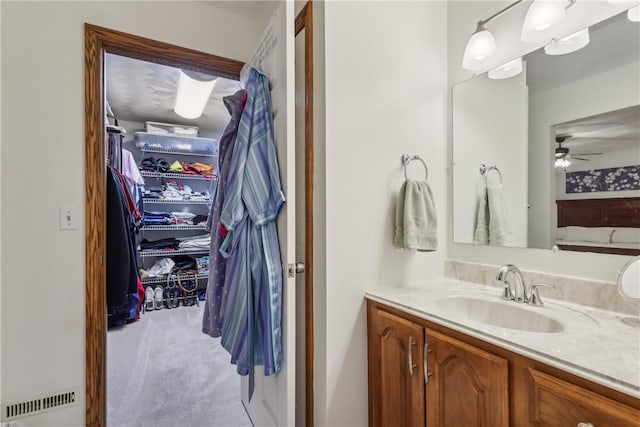 108 Covington Dr, Center Twp, PA 16001 - bathroom featuring vanity, a walk in closet, and a ceiling fan