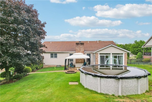 108 Covington Dr, Center Twp, PA 16001 - rear view of property featuring a gazebo, an outdoor fire pit, a sunroom, and a chimney